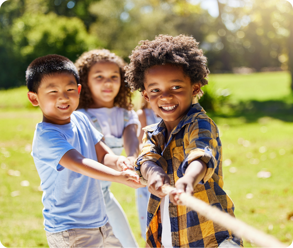 Kids playing tug-of-war outdoors