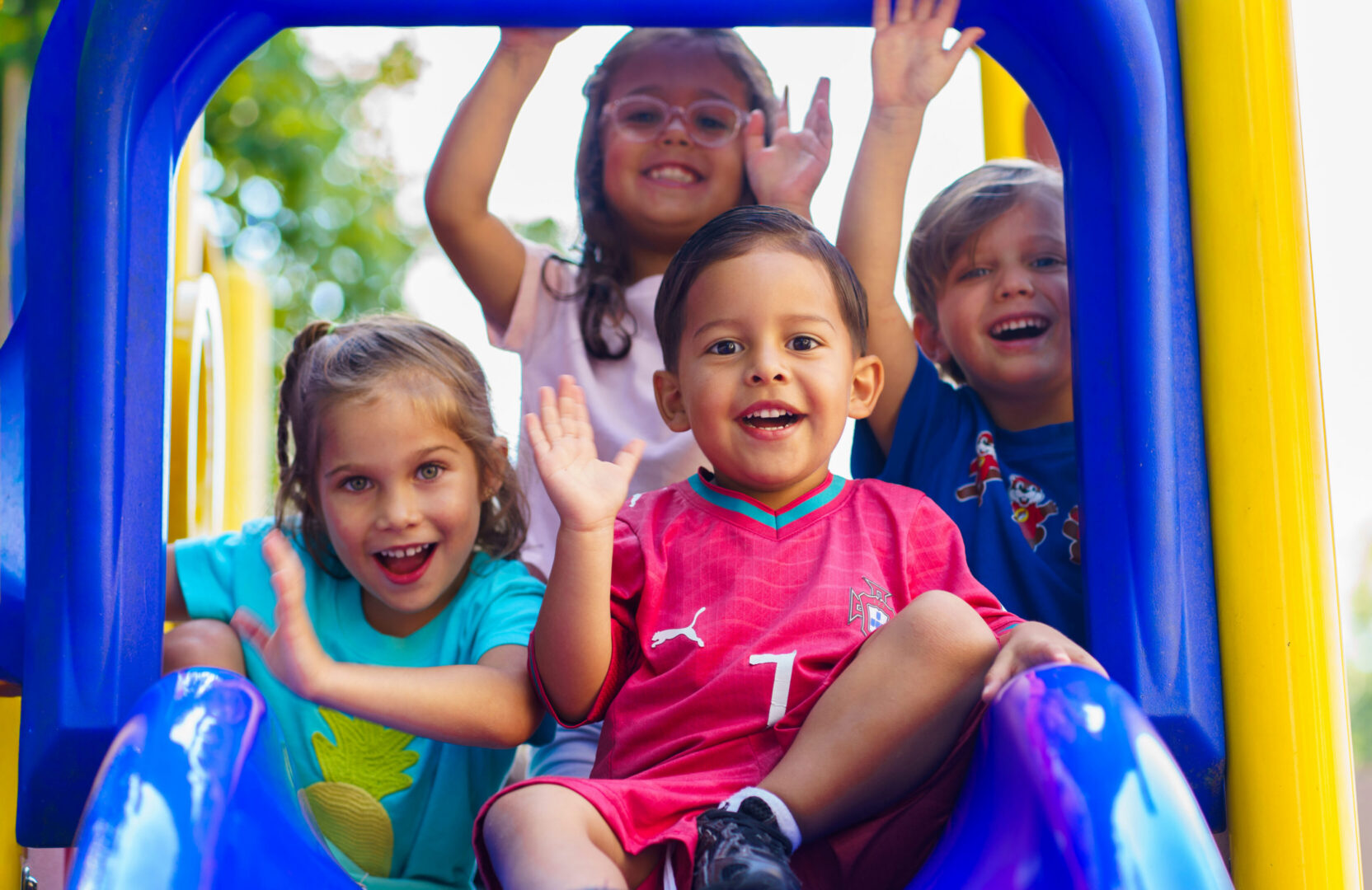 Children enjoying playtime on a slide