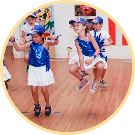 Children performing a dance in colorful outfits.