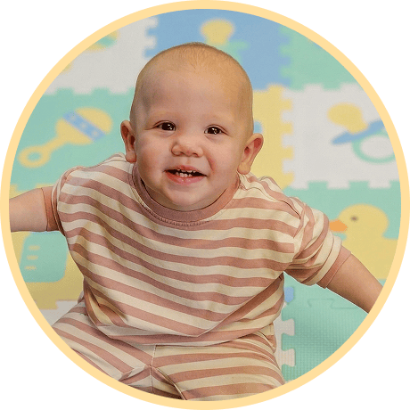 Smiling baby in striped outfit