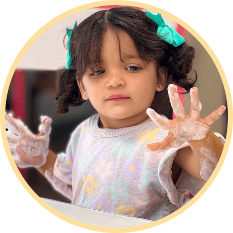Child playing with soapy hands