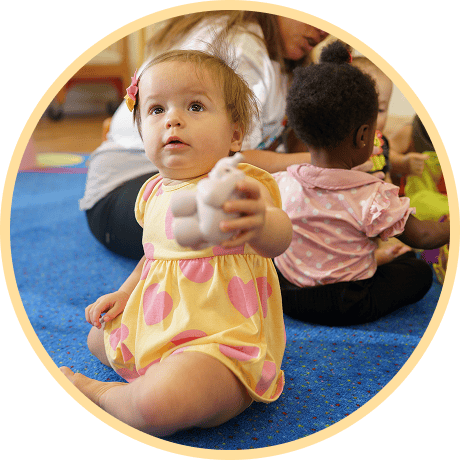 Child playing with a toy on the floor